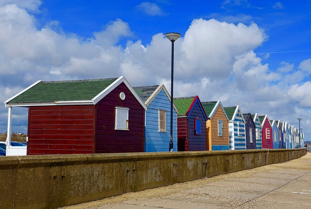 Red and blue beach huts on an English seafront